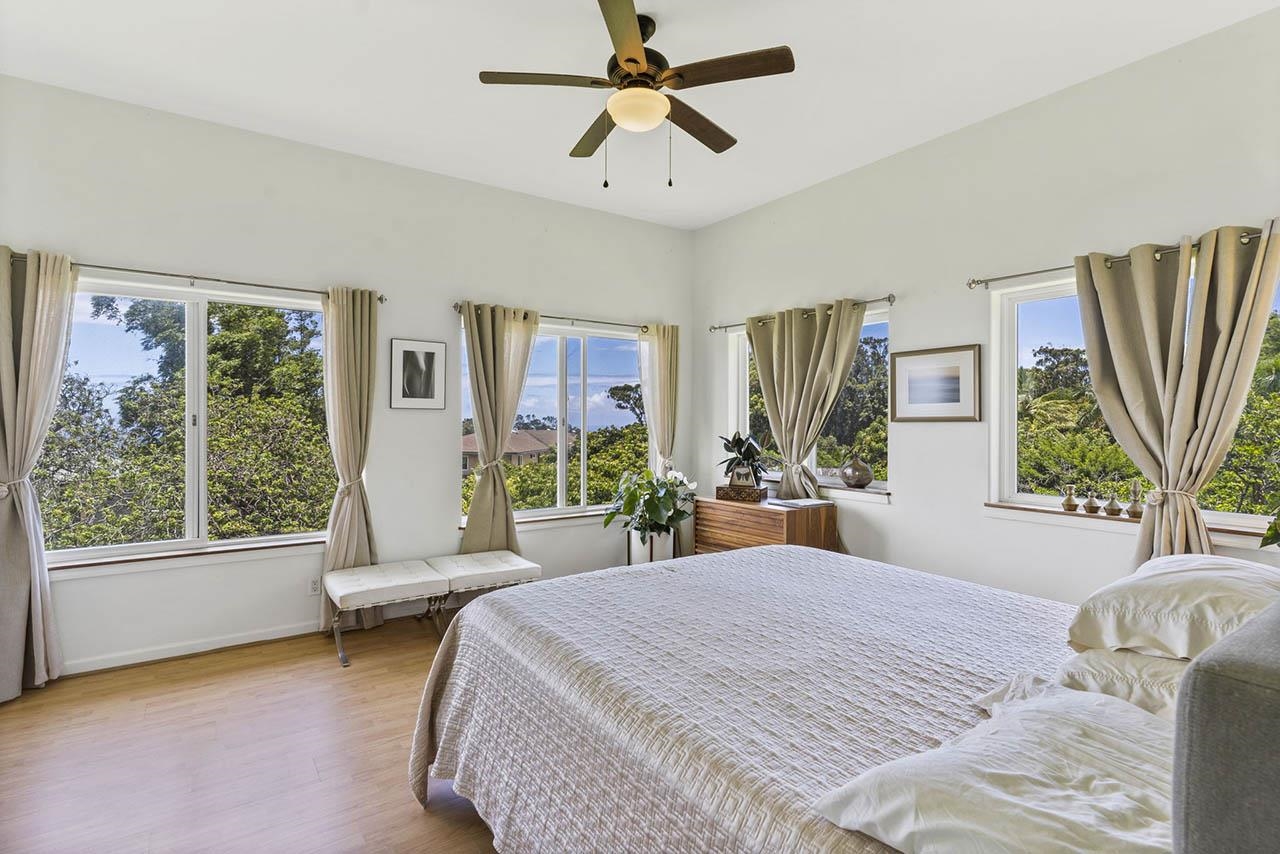 88 Kamalii Place Haiku, HI 96708 - Photo 9 of 24 a bedroom with a bed couch and large window