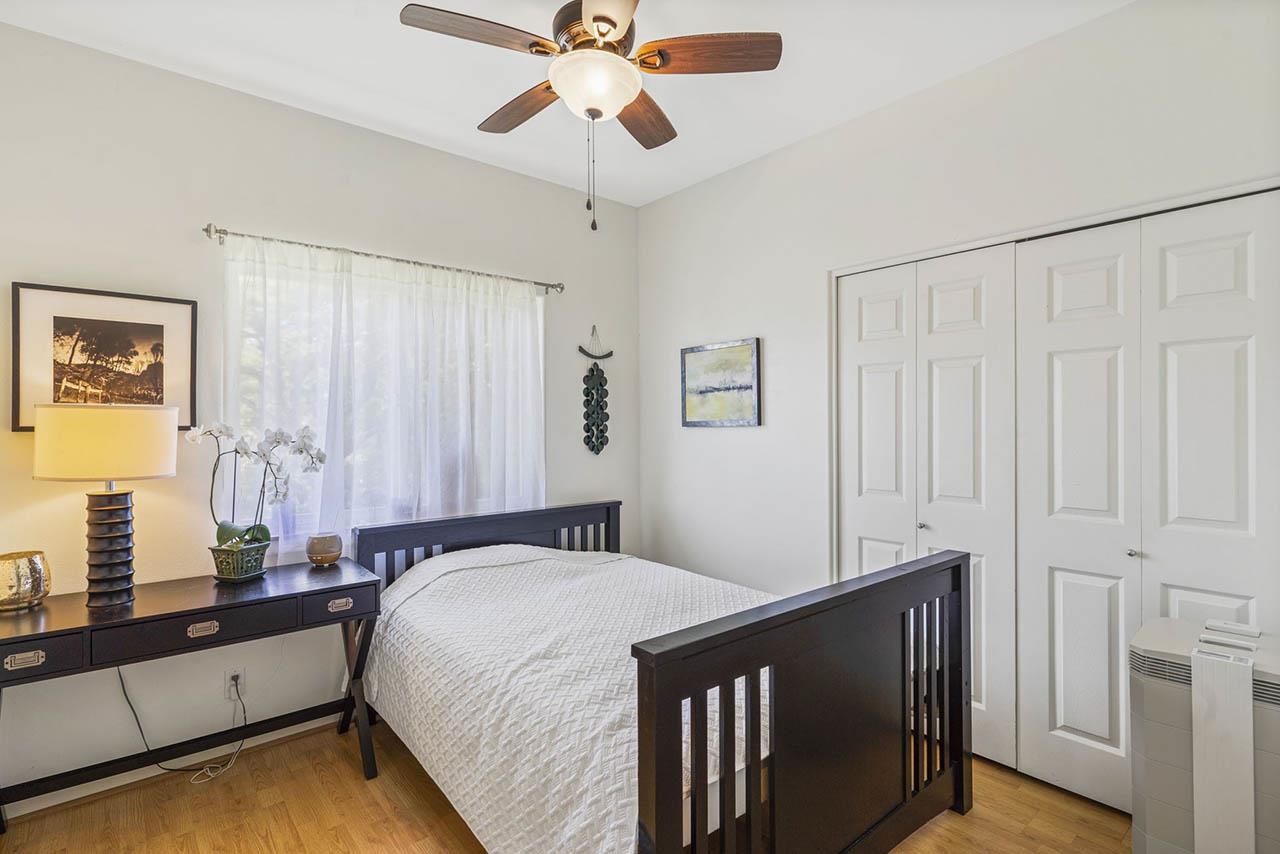 88 Kamalii Place Haiku, HI 96708 - Photo 10 of 24 a bedroom with a bed and a chandelier