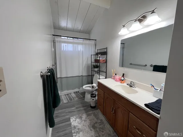 a bathroom with a sink toilet and shower