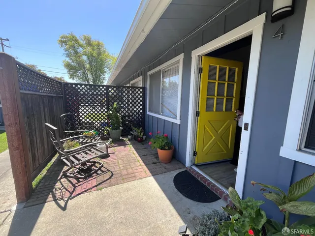 a view of a chairs and table in the patio