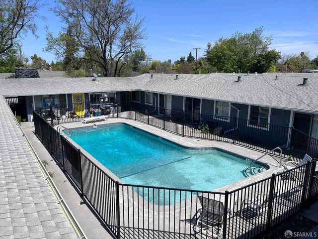a view of a house with pool and yard