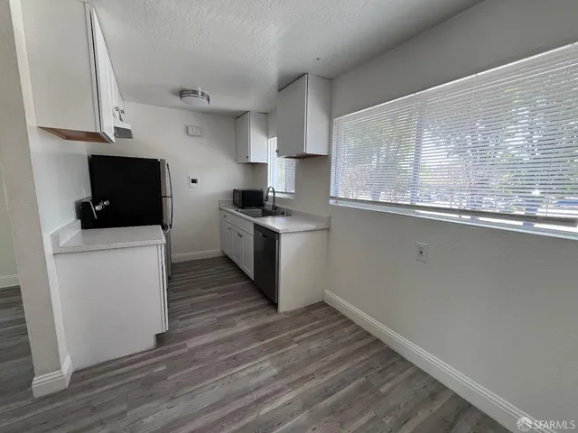 a kitchen with a sink a stove and cabinets
