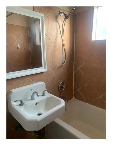 a bathroom with a sink a mirror and a shower