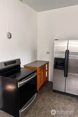 a kitchen with a stove and a refrigerator