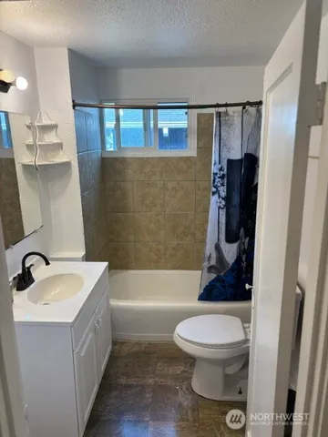 a bathroom with a sink a toilet and a bathtub
