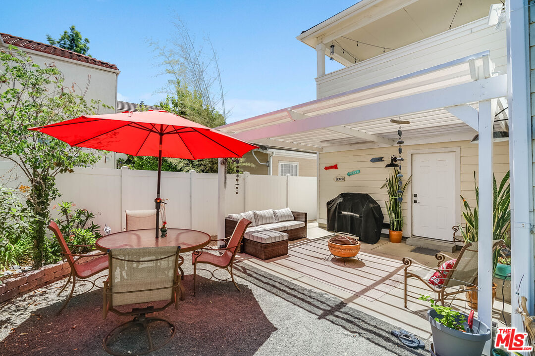 182 Comanche Topanga, CA 90290 - Photo 4 of 24 a view of a patio with a table and chairs under an umbrella