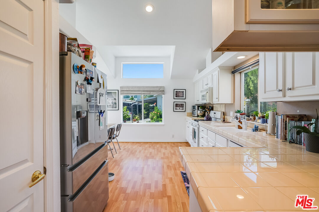 182 Comanche Topanga, CA 90290 - Photo 6 of 24 a kitchen with stainless steel appliances granite countertop a refrigerator and a sink