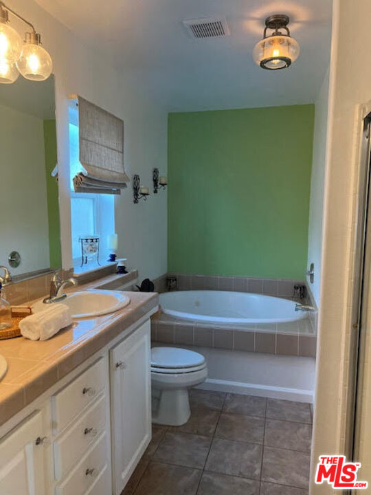 182 Comanche Topanga, CA 90290 - Photo 8 of 24 a bathroom with a granite countertop sink a toilet a mirror and bathtub