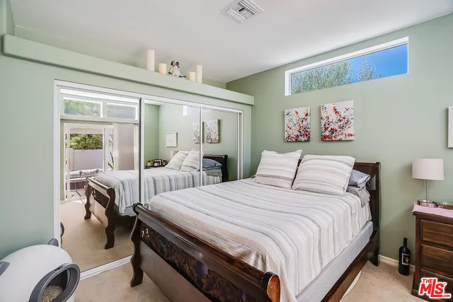 a bedroom with a bed and a table