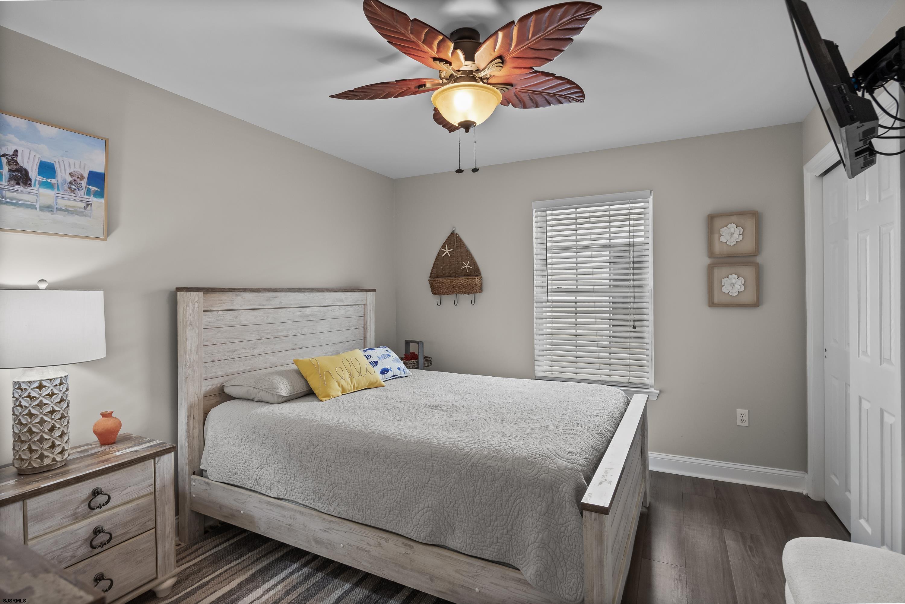 405 Atlantic Avenue, Unit 1 Ocean City, NJ 08226 - Photo 25 of 39 a bedroom with a bed and a chandelier