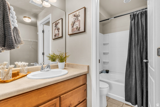 1136 West Spencer Road, Unit Y203 Pleasant Grove, UT 84062 - Photo 17 of 26 Full bathroom featuring vanity, a walk in closet, shower / bath combo with shower curtain, and light tile patterned flooring