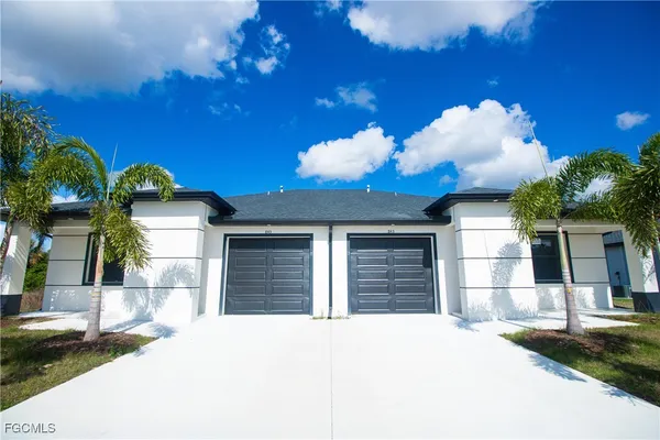 a front view of a house with a yard and garage