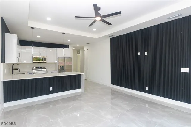 a view of kitchen with stainless steel appliances cabinets
