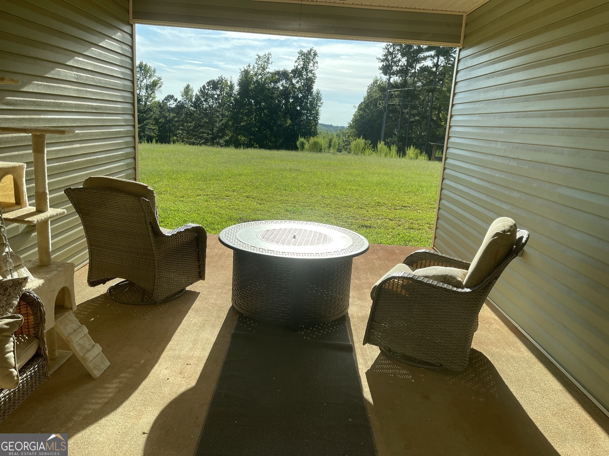 1911 Ellis Road Hogansville, GA 30230 - Photo 26 of 49 a view of a patio with a table chairs and a backyard