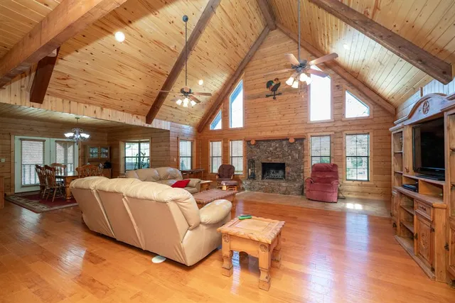a living room with fireplace furniture and a flat screen tv