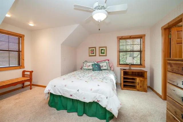 a bedroom with a large bed and a chandelier