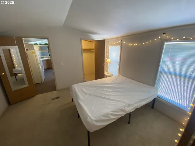 a bedroom with a bed and a mirror