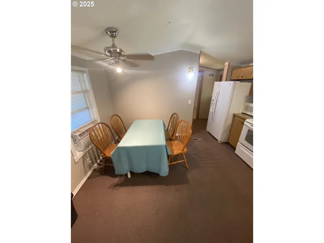 a living room with furniture and a ceiling fan