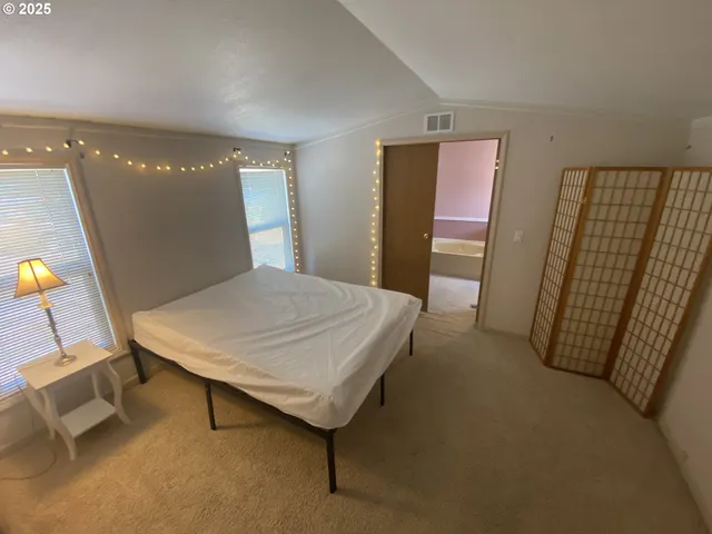 a room with a table and paintings on the wall