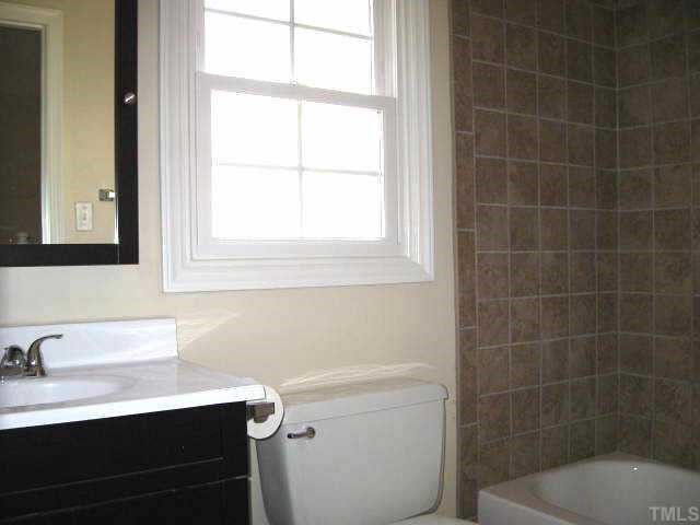 122 Stedwick Place Durham, NC 27712 - Photo 11 of 12 a bathroom with a sink toilet a mirror and shower