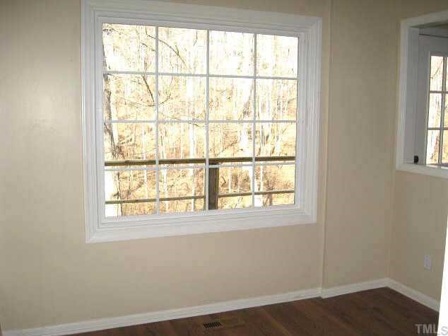 122 Stedwick Place Durham, NC 27712 - Photo 6 of 12 an empty room with wooden floor and windows