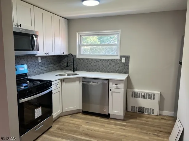 a kitchen with a stove and a microwave