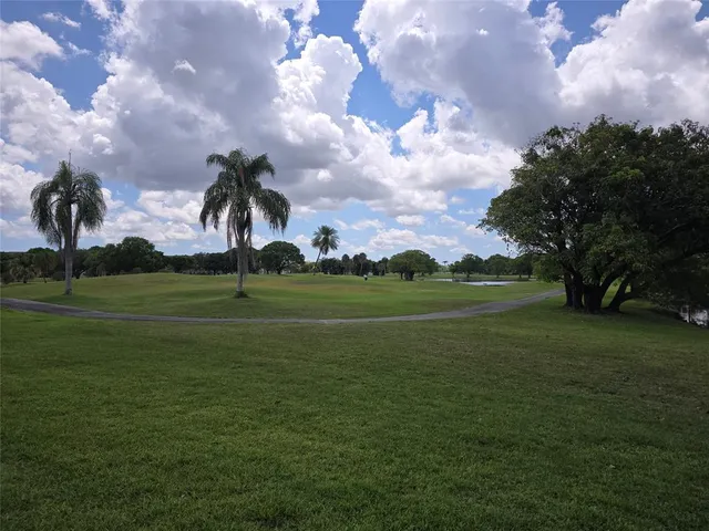 a view of a golf course with a house