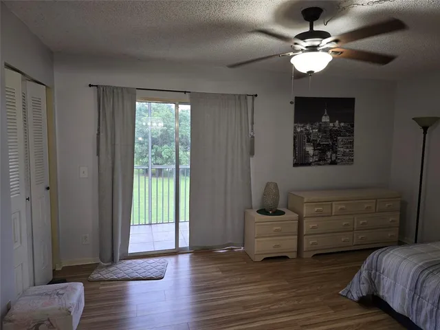 a bathroom with a sink a toilet a mirror a vanity and shower