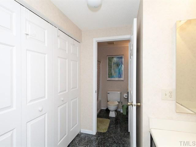 7722 Bernadette Lane Raleigh, NC 27615 - Photo 11 of 23 a bathroom with a toilet and a shower