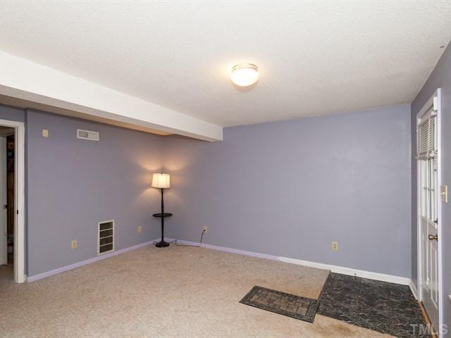 7722 Bernadette Lane Raleigh, NC 27615 - Photo 16 of 23 a view of an empty room with wooden floor and a window