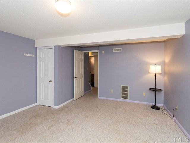 7722 Bernadette Lane Raleigh, NC 27615 - Photo 17 of 23 a view of a room with a table and a lamp