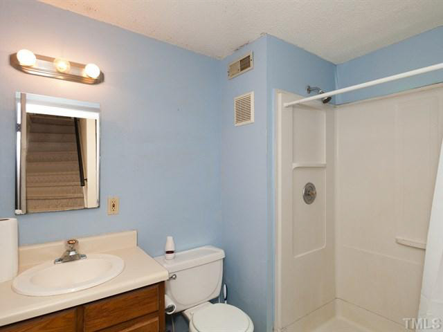 7722 Bernadette Lane Raleigh, NC 27615 - Photo 18 of 23 a bathroom with a sink toilet and shower
