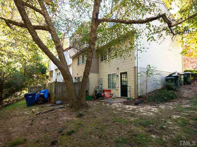 7722 Bernadette Lane Raleigh, NC 27615 - Photo 21 of 23 a view of a house with backyard and a tree
