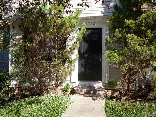 7722 Bernadette Lane Raleigh, NC 27615 - Photo 22 of 23 a couple of potted plants in front of door