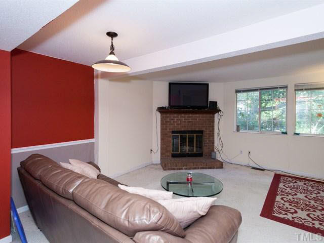 7722 Bernadette Lane Raleigh, NC 27615 - Photo 5 of 23 a living room with furniture and a fireplace