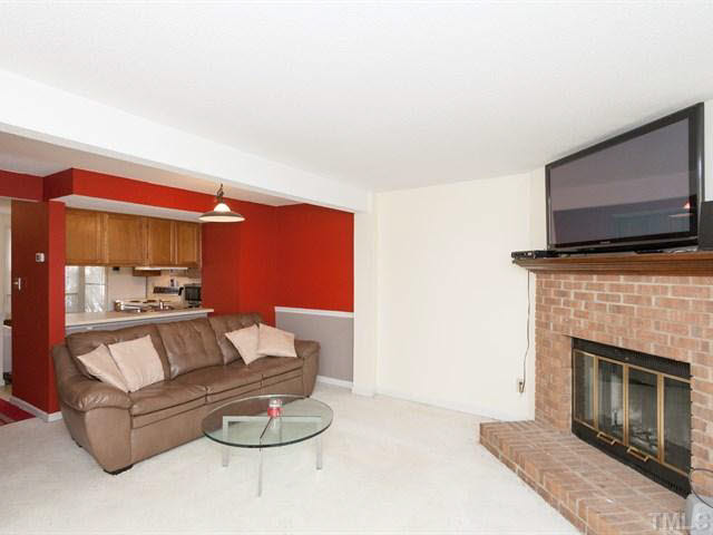 7722 Bernadette Lane Raleigh, NC 27615 - Photo 6 of 23 a living room with furniture and a fireplace