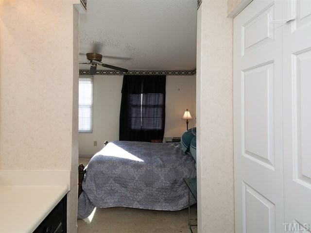 7722 Bernadette Lane Raleigh, NC 27615 - Photo 10 of 23 a bedroom with a bed and a window