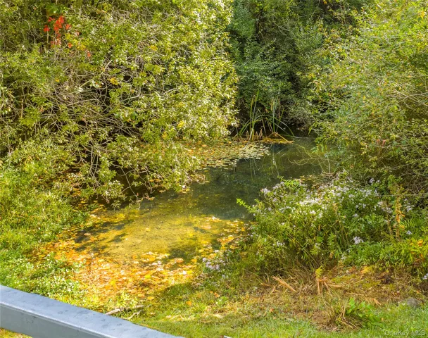 a view of a small yard with wooden fence and a bench