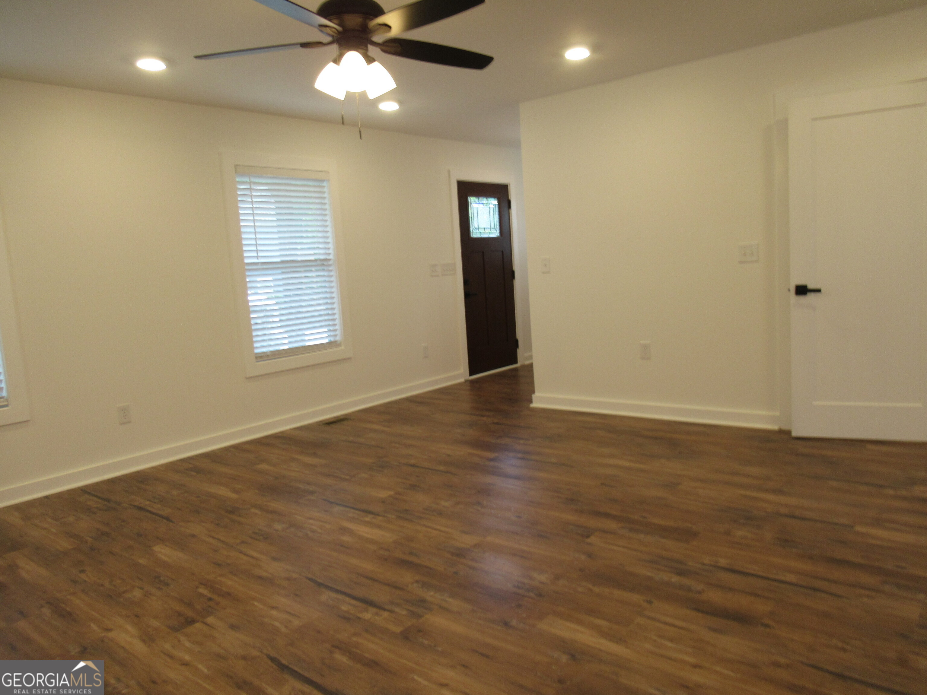 765 Old Kerns Road Dawsonville, GA 30534 - Photo 18 of 36 an empty room with wooden floor closet and windows