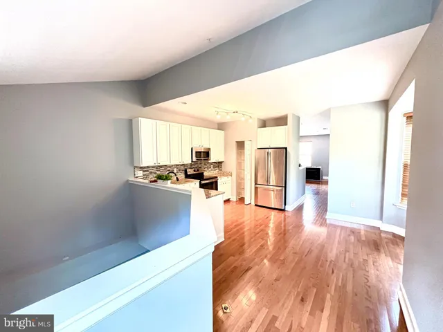 a view of open kitchen with wooden floor