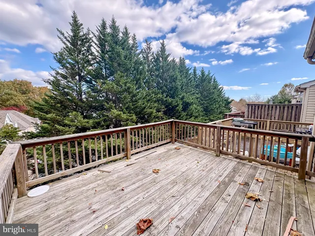 a balcony with wooden floor and fence