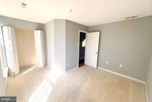 a view of a big room with windows and entryway