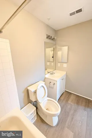 a bathroom with a sink a toilet and vanity