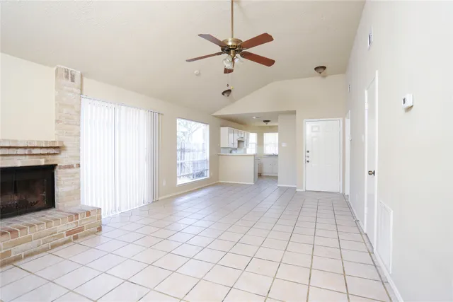 a view of an empty room with a fireplace