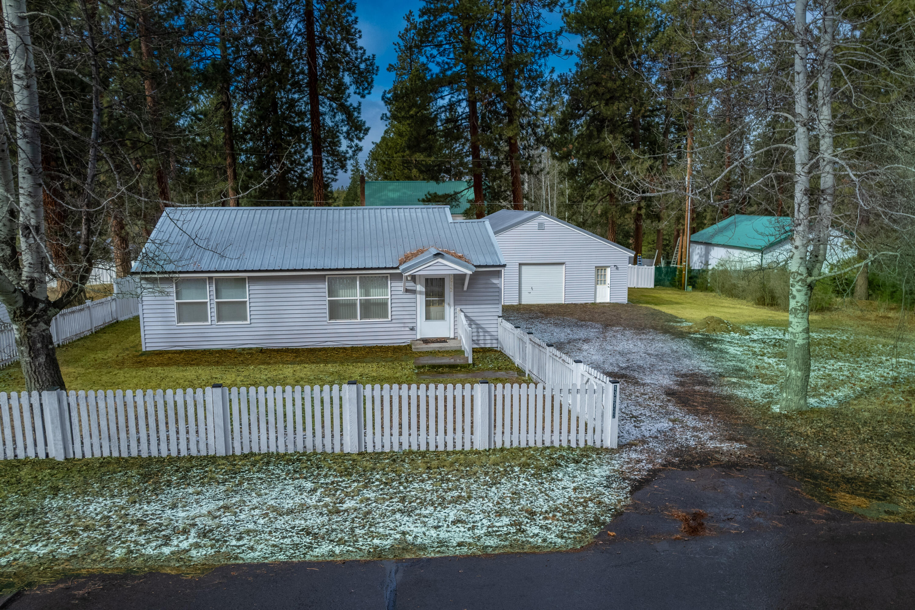 138722 Rhododendron Street Gilchrist, OR 97737 - Photo 2 of 36 a view of a house with a yard and fence