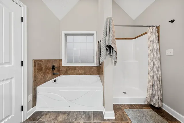 a bathroom with a tub and a shower