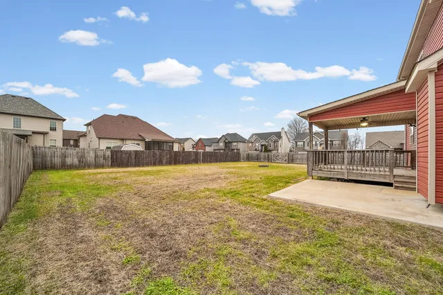 a view of an house with backyard space and balcony
