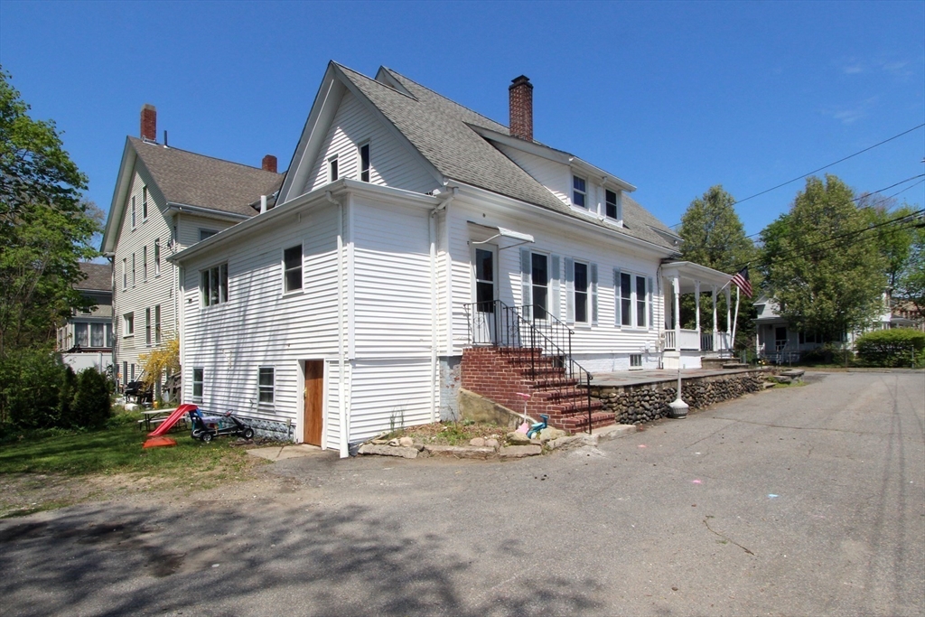 2 High Street Middleboro, MA 02346 - Photo 34 of 41 a view of a white house with a patio and a yard
