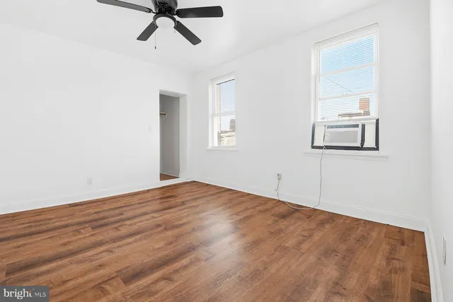 a view of empty room with ceiling fan