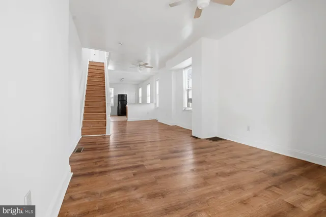 a view of a room with wooden floor and staircase